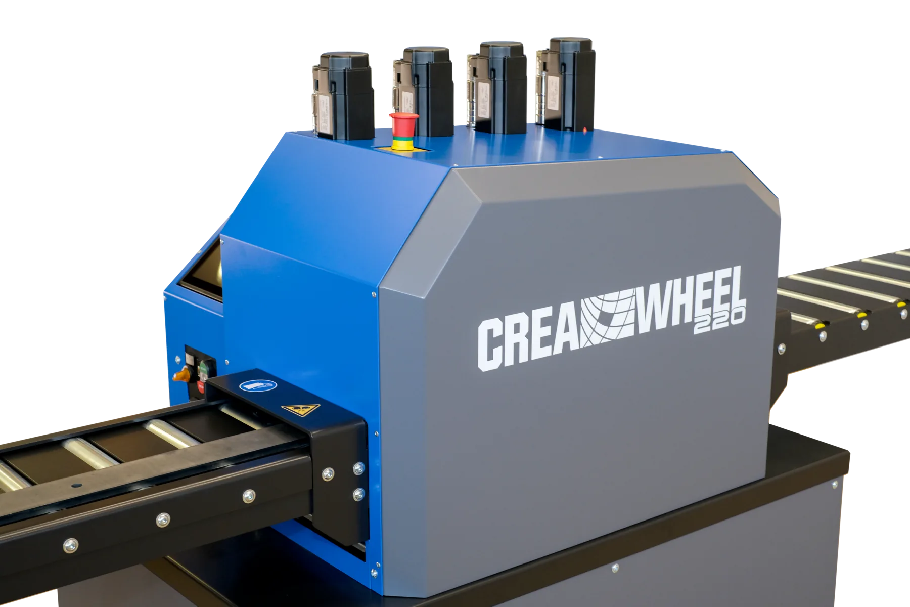 Gehäuse der CREA-WHEEL 220 aus der Nähe, Not-Aus-Pilz und Einlaufabdeckung mit Warnpiktogrammen