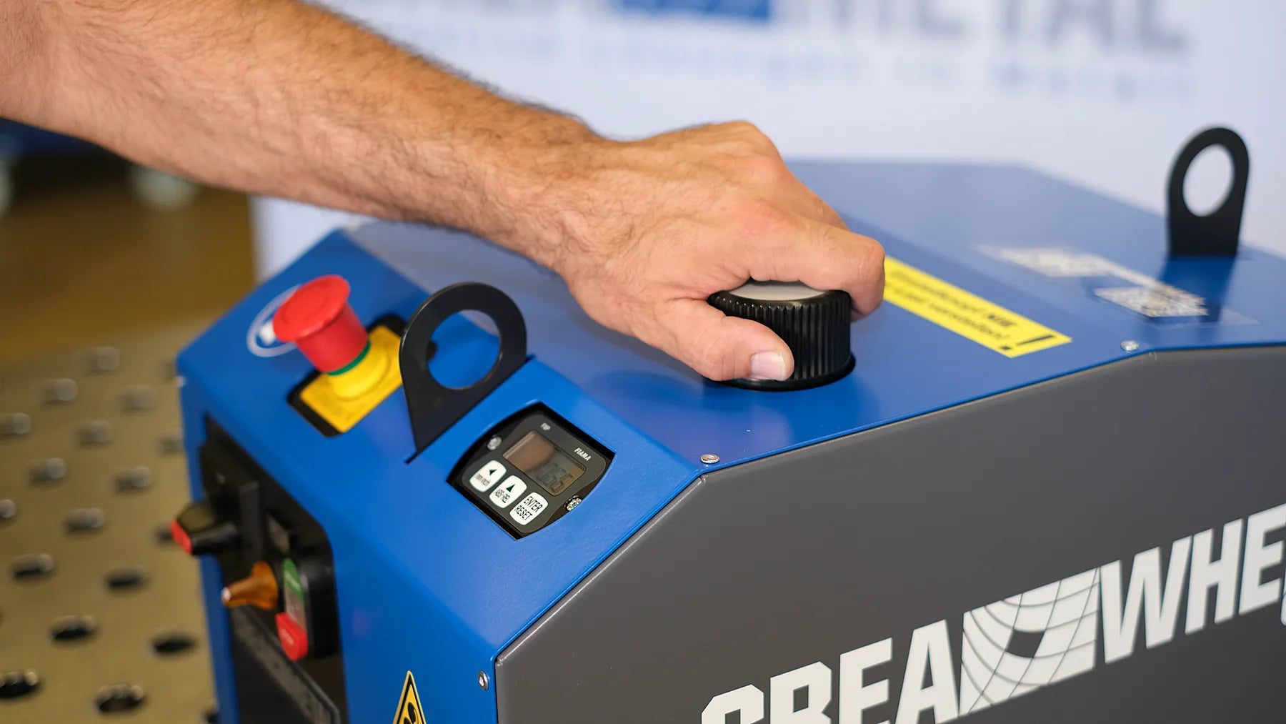 Hand am Einstellknopf der CREA-WHEEL 60 Basic, daneben Not-Aus und Digitalanzeige